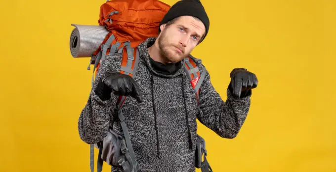 How do you wear a camera strap with a backpack?