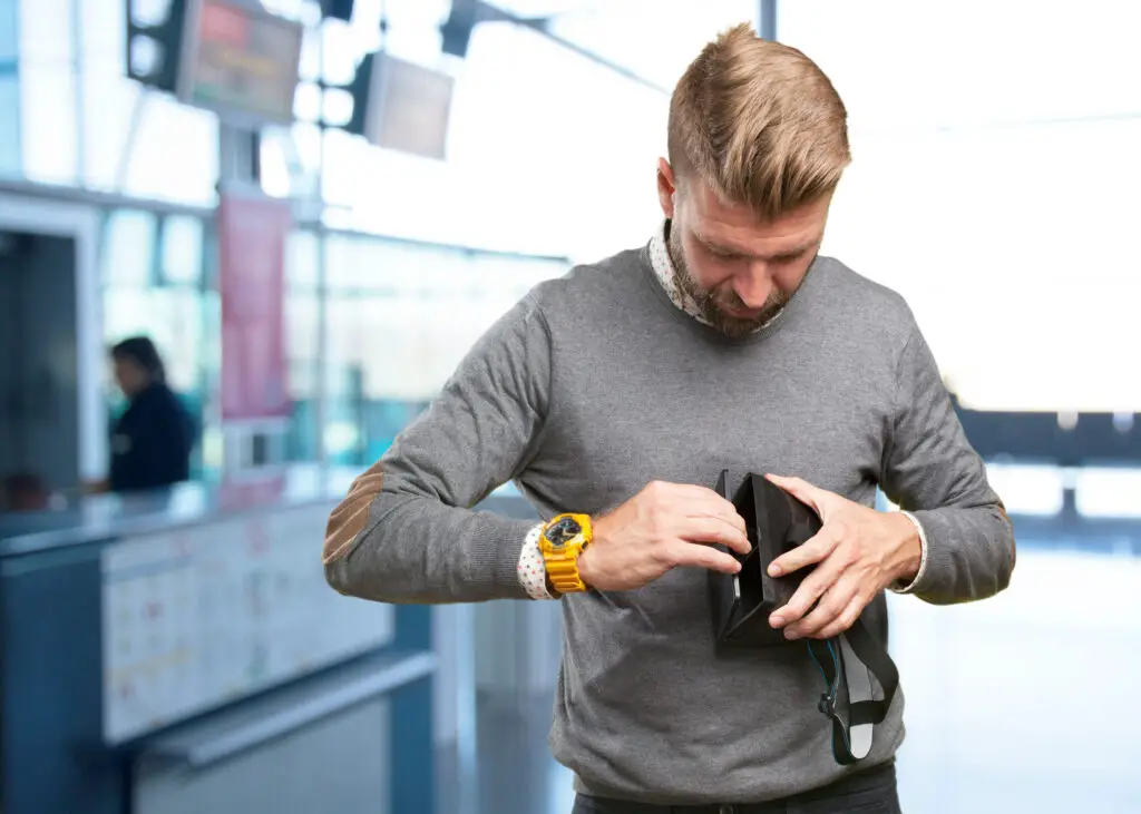 How to attach wrist strap to camera?