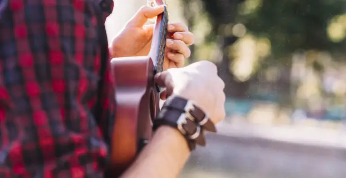 How to attach wrist strap to camera?